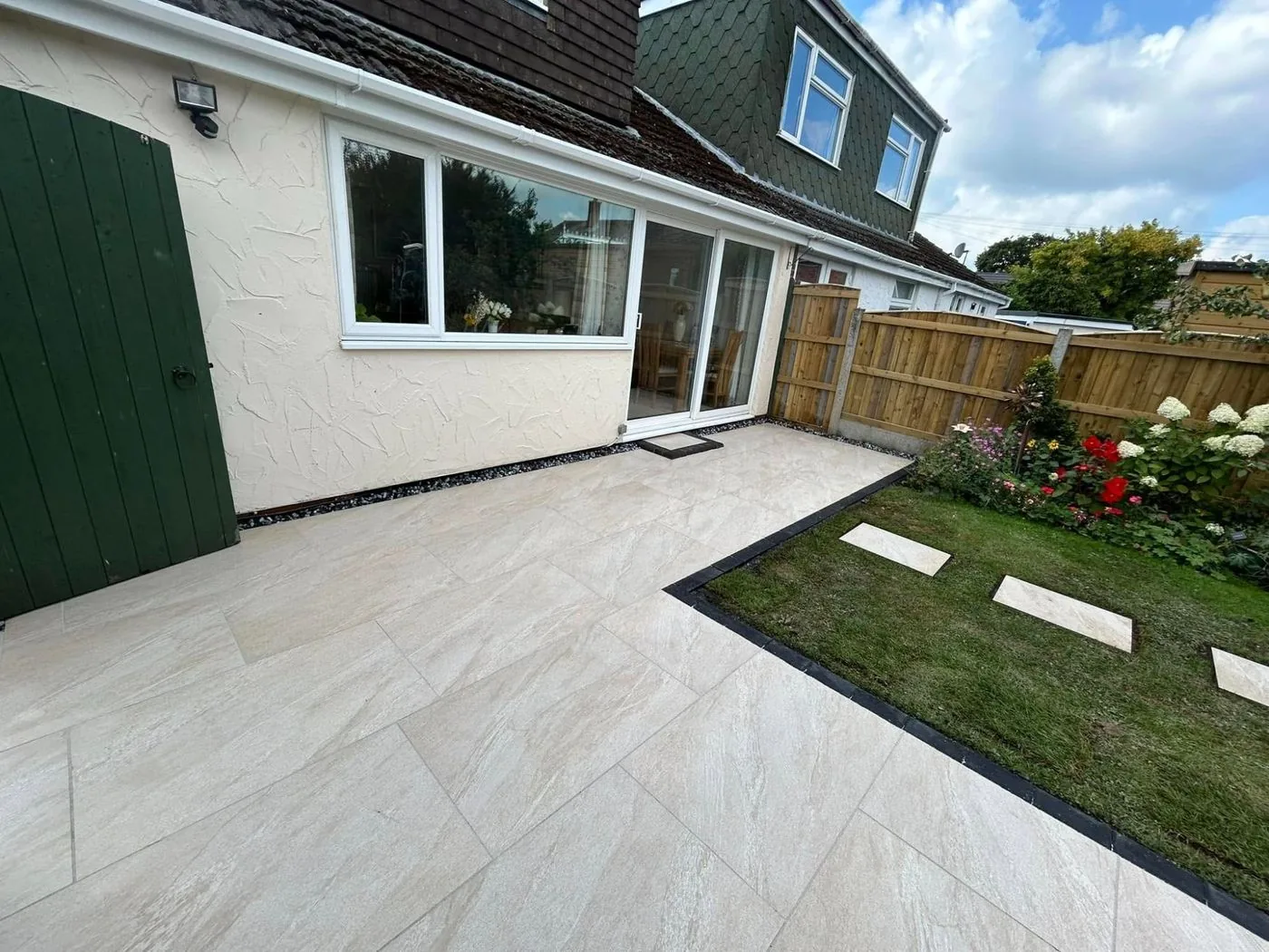 Full garden landscaping with artificial grass and garden room by Kingsmead Landscapes